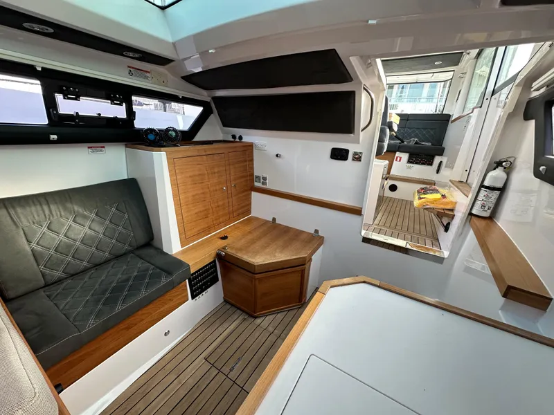 Slide: The Image of 2017 Axopar 37 interior with wood accents and seating area. - 13