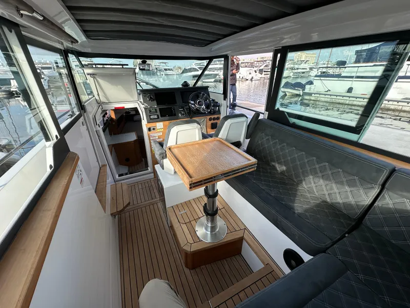 Slide: The Image of Interior of 2017 Axopar 37 boat with seating, table, and helm station. - 15