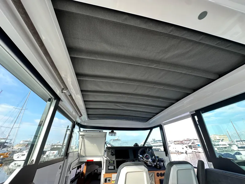 Slide: The Image of Interior view of 2017 Axopar 37 boat, featuring helm and seating area. - 16