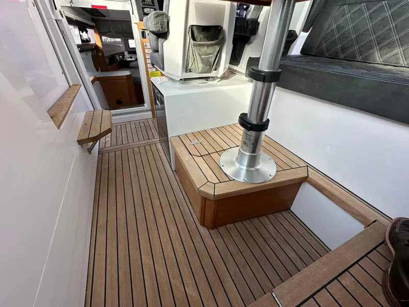 Slide: The Image of 2017 Axopar 37 interior with wood flooring and seating area. - 17