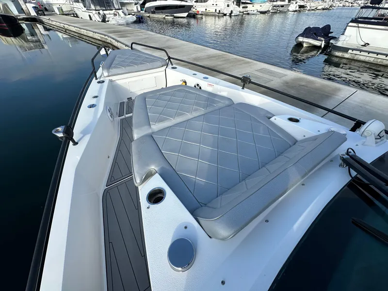 Slide: The Image of 2017 Axopar 37 boat with cushioned seating at marina dock. - 20