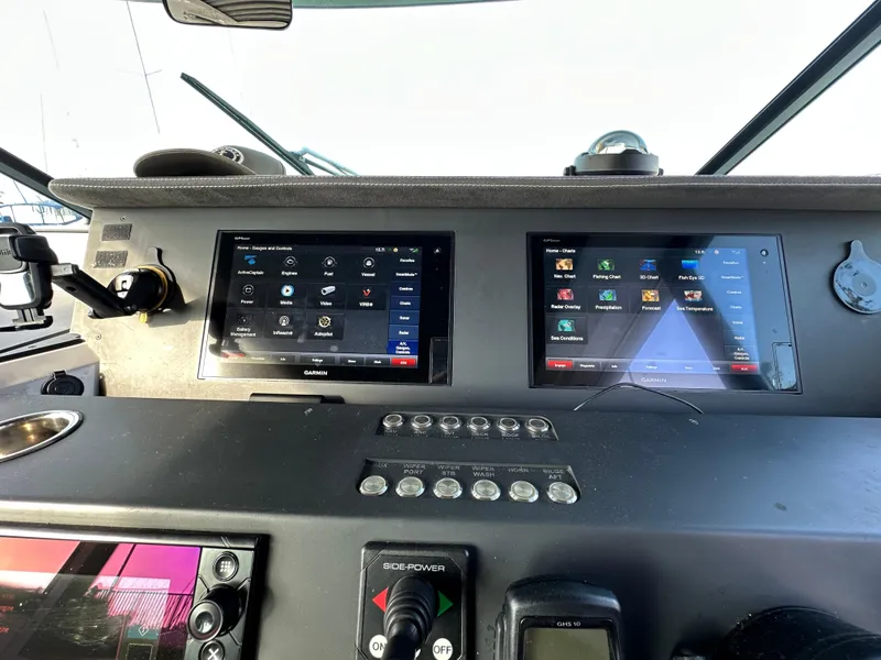Slide: The Image of Control panel of a 2017 Axopar 37 boat with dual navigation screens. - 28