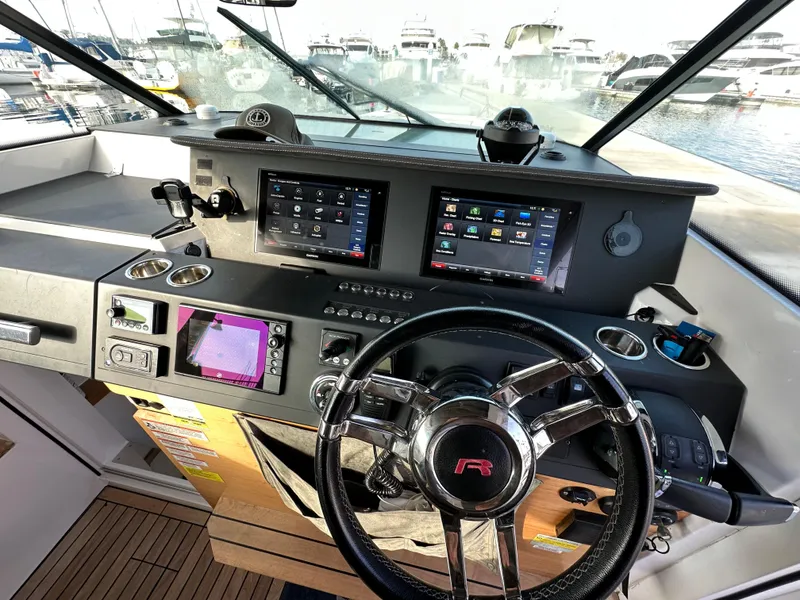 Slide: The Image of 2017 Axopar 37 boat dashboard with modern navigation screens and steering wheel. - 29