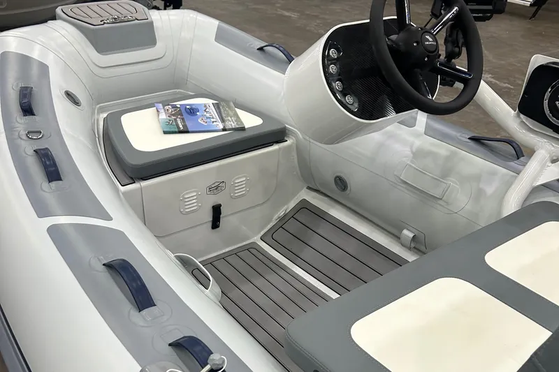 Slide: The Image of 2024 Highfield Classic 310 FCT boat interior with steering console and seating. - 2