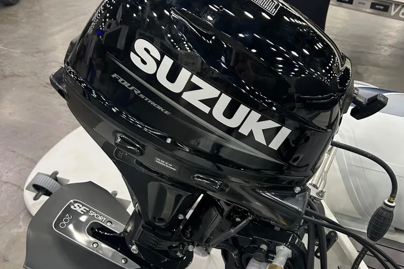 Slide: The Image of 2024 Highfield Classic 310 FCT with Suzuki outboard motor, showcased indoors. - 3