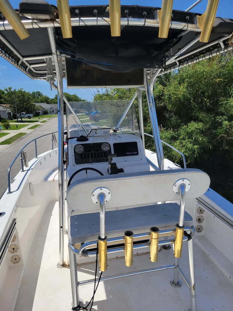 Slide: The Image of 2001 Century 2300 Center Console boat with fishing rod holders and canopy. - 8