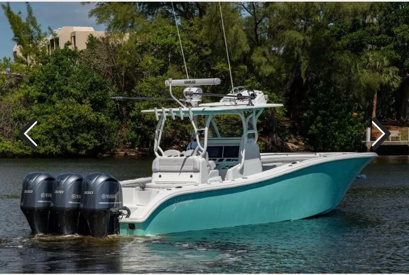 Slide: The Image of 2018 Yellowfin 36 boat with four Yamaha outboard engines on a calm waterway. - 1