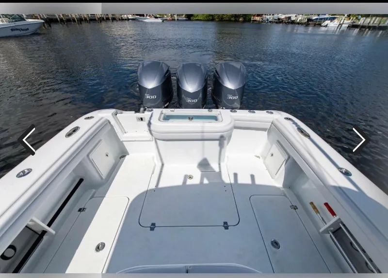 Slide: The Image of 2018 Yellowfin 36 boat with triple outboard engines on calm water. - 10