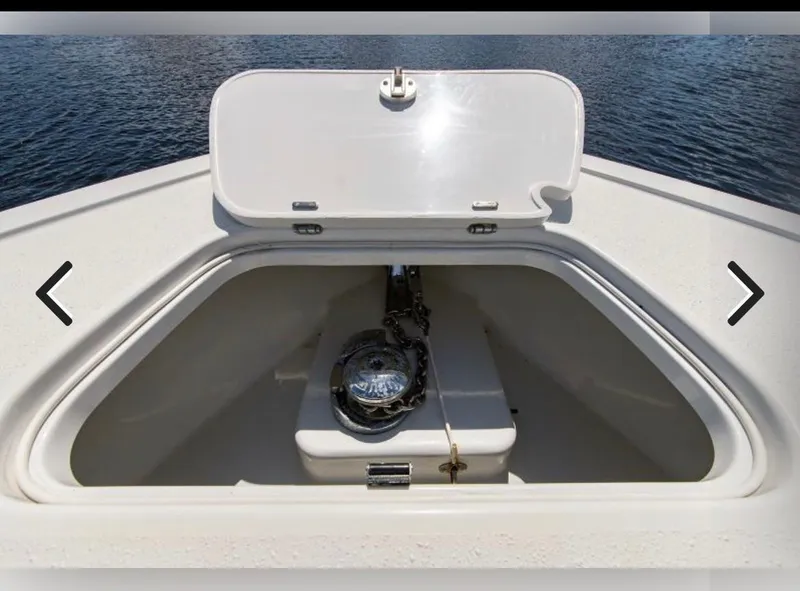 Slide: The Image of 2018 Yellowfin 36 boat anchor compartment with open hatch, on calm water. - 11