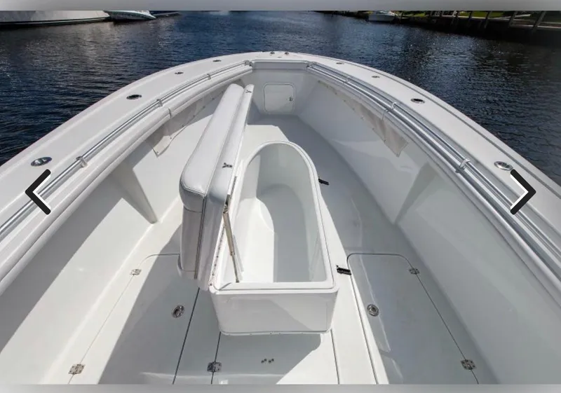 Slide: The Image of 2018 Yellowfin 36 boat interior with open storage compartment on calm water. - 12