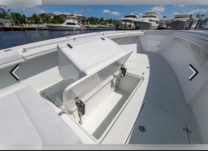 Slide: The Image of 2018 Yellowfin 36 boat with open storage compartment, docked at marina. - 13