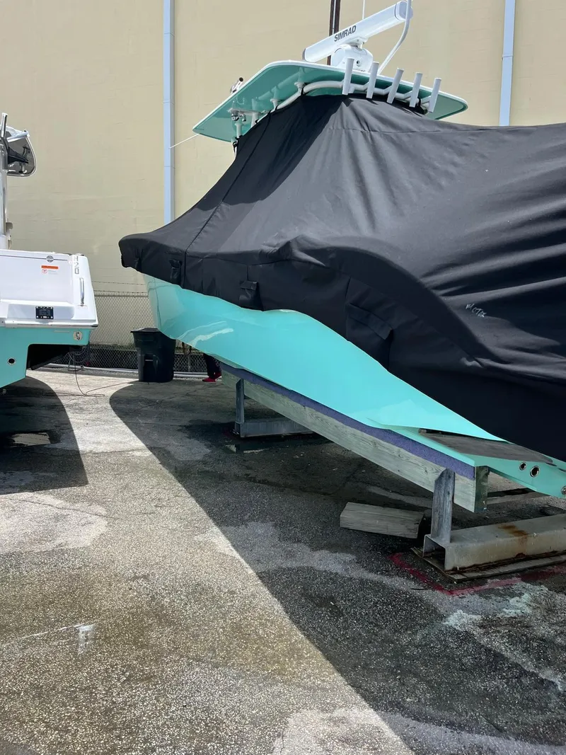 Slide: The Image of 2018 Yellowfin 36 boat covered, parked on a concrete surface. - 17