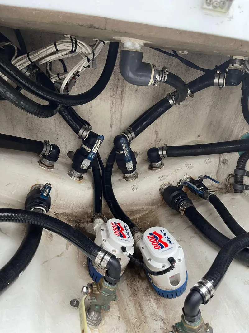 Slide: The Image of Engine compartment of a 2018 Yellowfin 36 boat, showing hoses and pumps. - 21