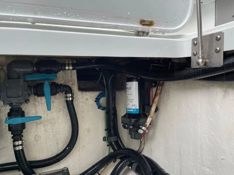 Slide: The Image of 2018 Yellowfin 36 boat plumbing system with valves and hoses. - 23