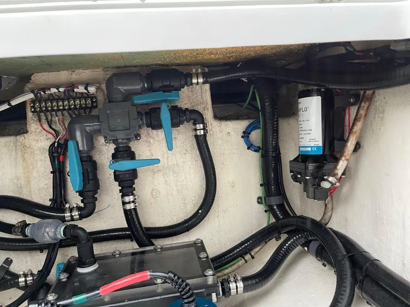 Slide: The Image of Engine compartment of a 2018 Yellowfin 36 boat, showcasing plumbing and wiring systems. - 24