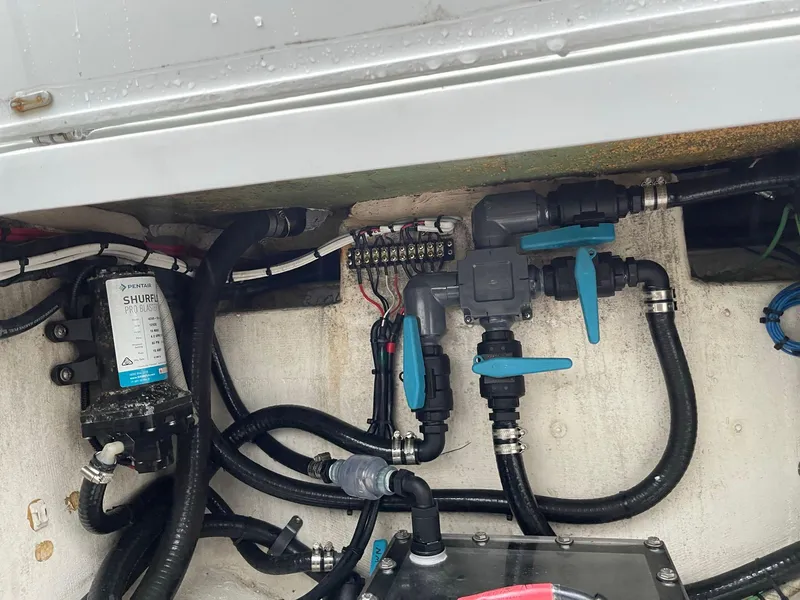 Slide: The Image of Engine compartment of a 2018 Yellowfin 36 boat, showing plumbing and wiring components. - 25