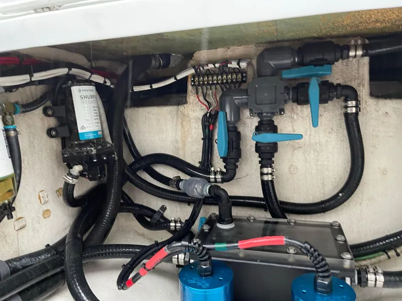 Slide: The Image of Engine compartment of a 2018 Yellowfin 36 boat, showcasing wiring and plumbing components. - 26
