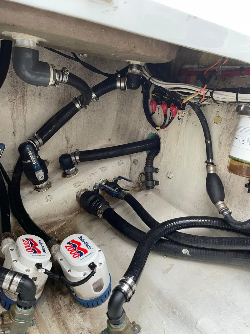 Slide: The Image of Engine compartment of a 2018 Yellowfin 36 boat with hoses and pumps. - 28