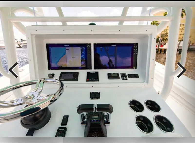 Slide: The Image of 2018 Yellowfin 36 boat dashboard with dual navigation screens and steering wheel. - 3