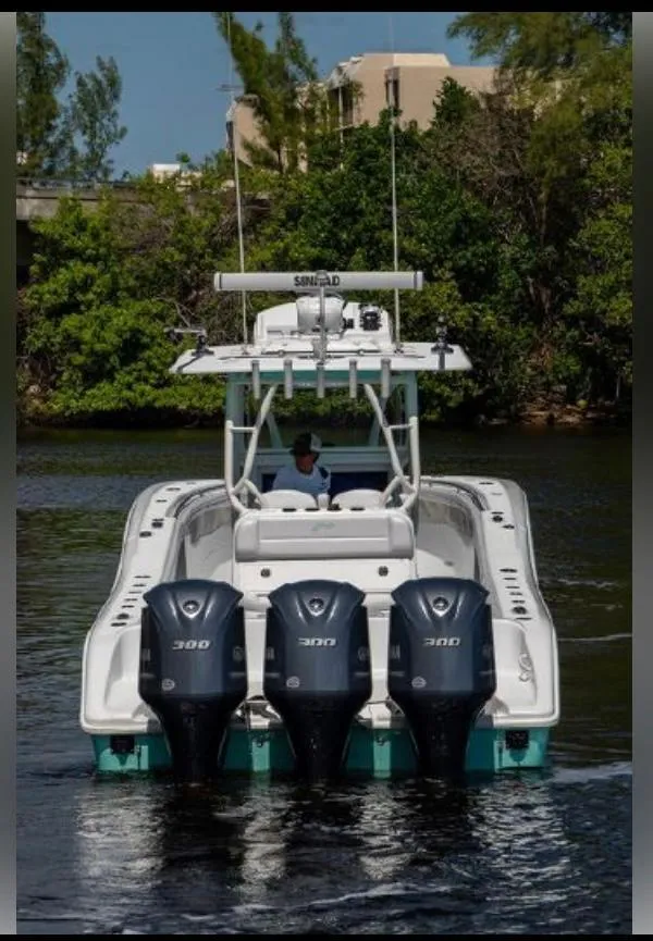 Slide: The Image of 2018 Yellowfin 36 boat with triple 300 engines on a calm waterway. - 5