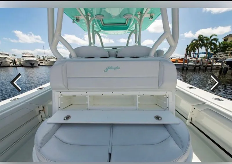 Slide: The Image of 2018 Yellowfin 36 boat interior with seating and storage, docked at marina. - 8
