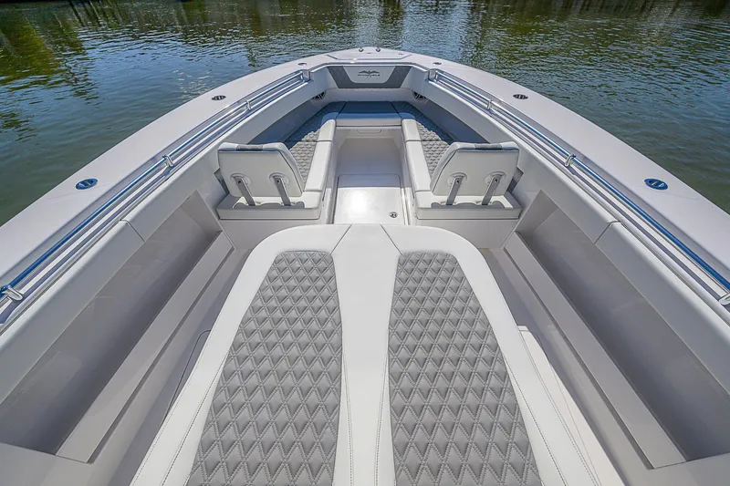 Slide: The Image of 2024 Invincible 39 Open Fisherman boat interior with cushioned seating and sleek design. - 25