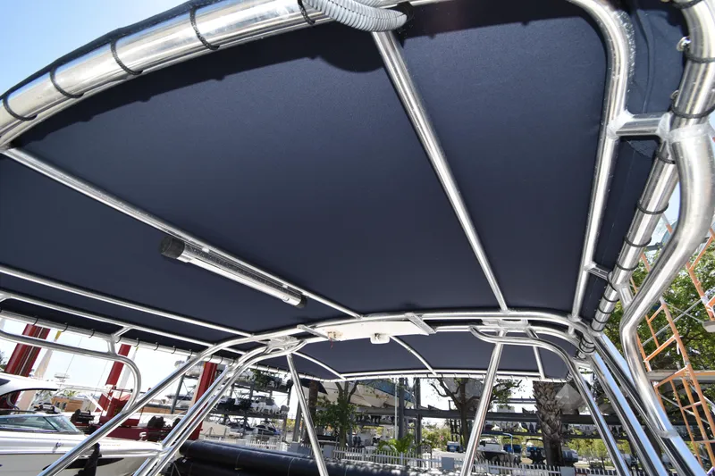 Slide: The Image of 2002 Intrepid 323 boat canopy with metal frame, outdoor setting. - 15
