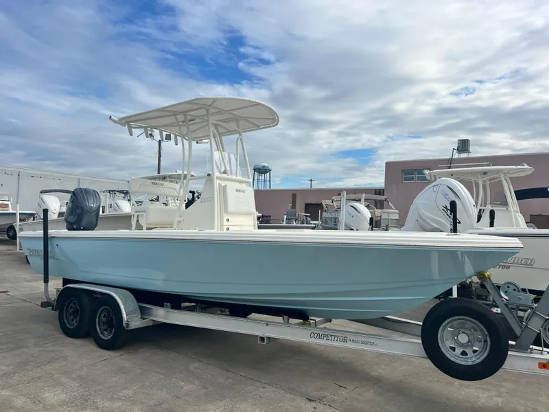 The Image of 2025 Pathfinder 2200 TRS boat on trailer, parked outdoors under cloudy sky. - 1