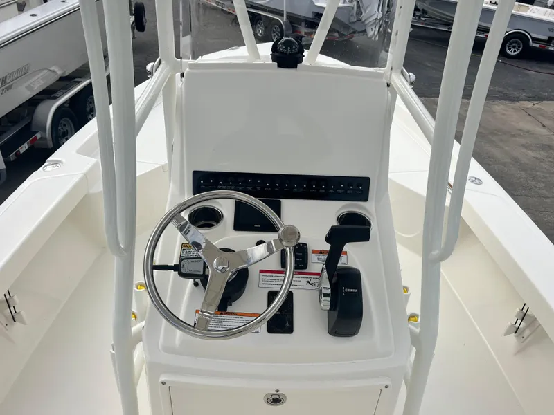 Slide: The Image of 2025 Pathfinder 2200 TRS boat console with steering wheel and controls. - 10