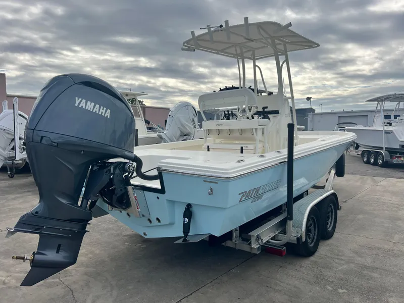 Slide: The Image of 2025 Pathfinder 2200 TRS boat with Yamaha engine on trailer, under cloudy sky. - 5