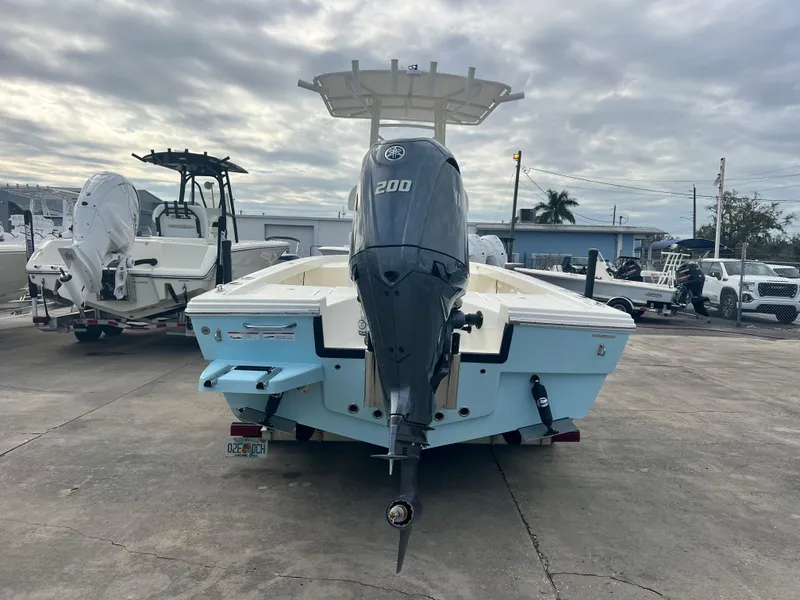 Slide: The Image of 2025 Pathfinder 2200 TRS boat with Yamaha 200 engine, parked outdoors. - 6