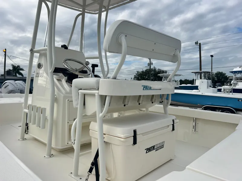 Slide: The Image of 2025 Pathfinder 2200 TRS boat interior with seating and steering console. - 7