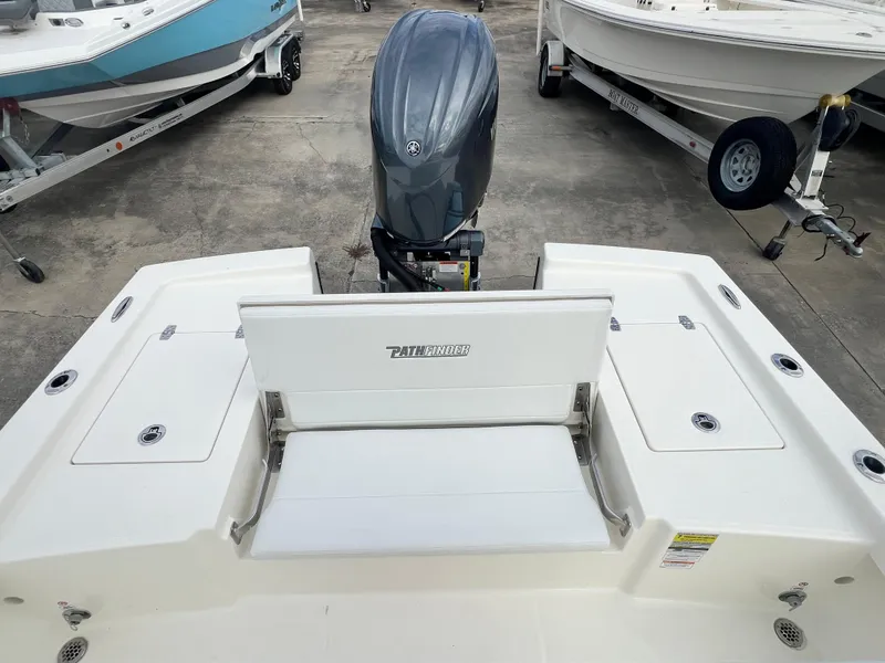 Slide: The Image of 2025 Pathfinder 2200 TRS boat with outboard motor, rear seating, and storage compartments. - 8