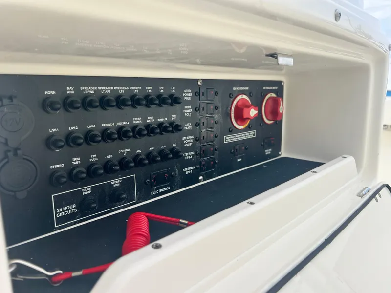 Slide: The Image of Control panel of a 2025 Pathfinder 2200 TRS boat, featuring switches and circuit breakers. - 9