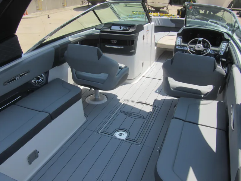 Slide: The Image of 2025 Chaparral 307 SSX boat interior with sleek seating and modern dashboard design. - 10