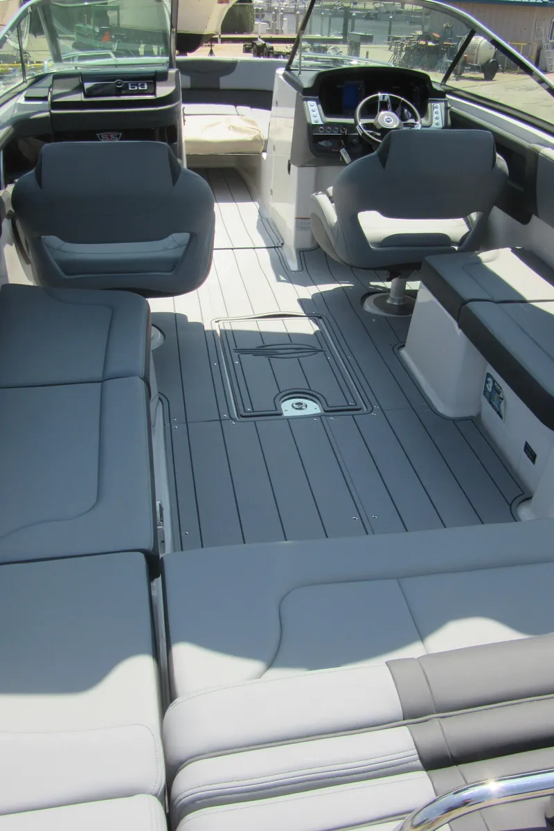 Slide: The Image of 2025 Chaparral 307 SSX boat interior with sleek seating and modern dashboard design. - 12