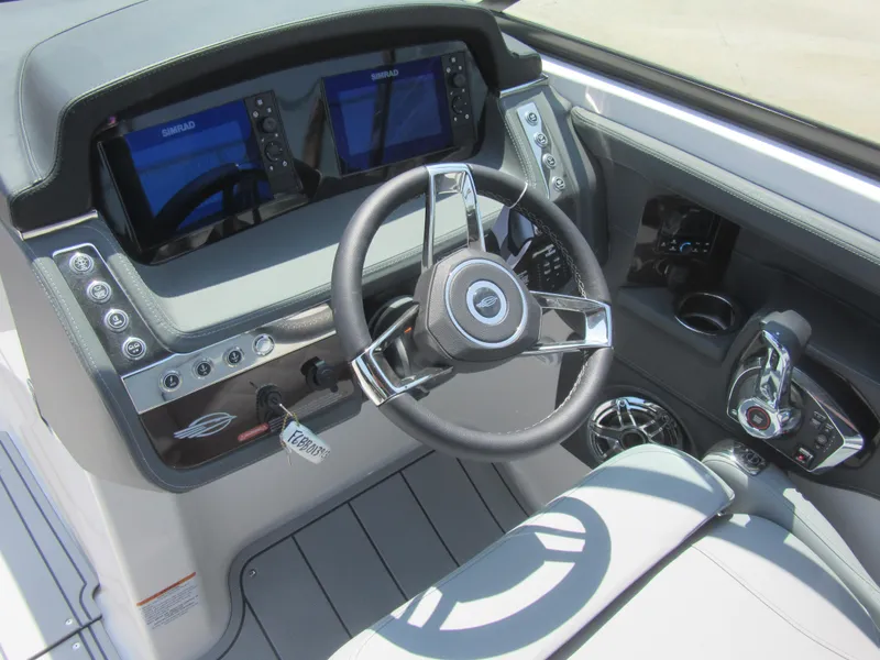 Slide: The Image of Cockpit of 2025 Chaparral 307 SSX boat with modern steering and dual displays. - 15