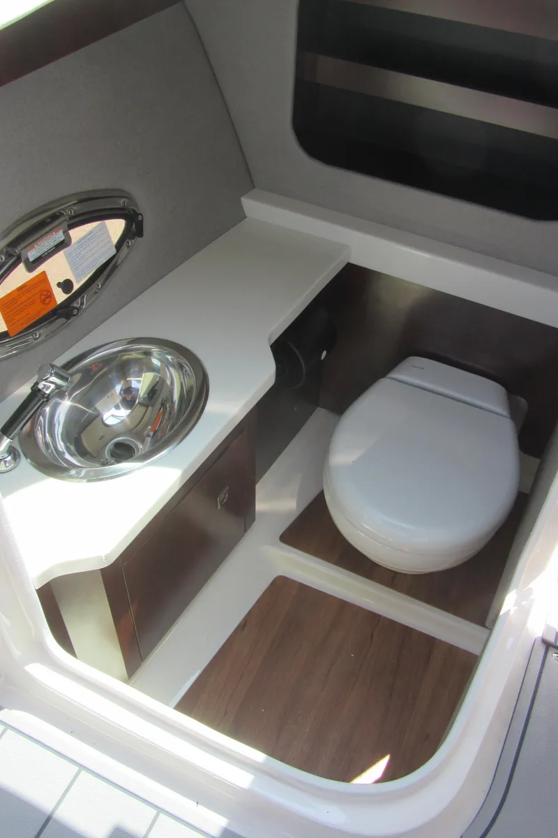 Slide: The Image of 2025 Chaparral 307 SSX boat interior bathroom with sink and toilet. - 19