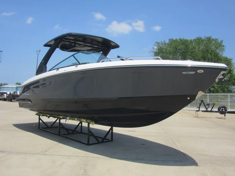 Slide: The Image of 2025 Chaparral 307 SSX boat displayed on a stand, under a clear blue sky. - 4