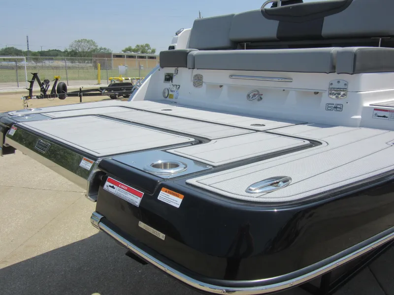 Slide: The Image of 2025 Chaparral 307 SSX boat with sleek swim platform and modern design. - 9