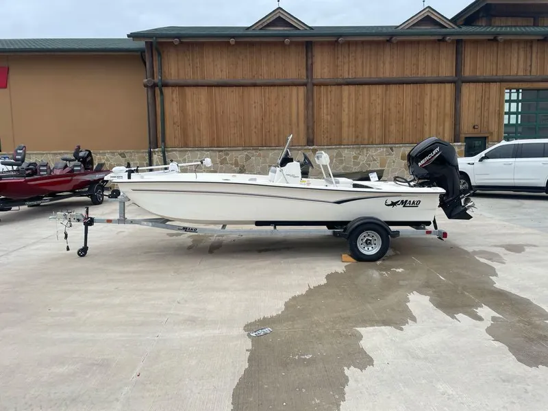 Slide: The Image of 2025 Mako Pro Skiff 17 CC boat on trailer, parked outdoors. - 0