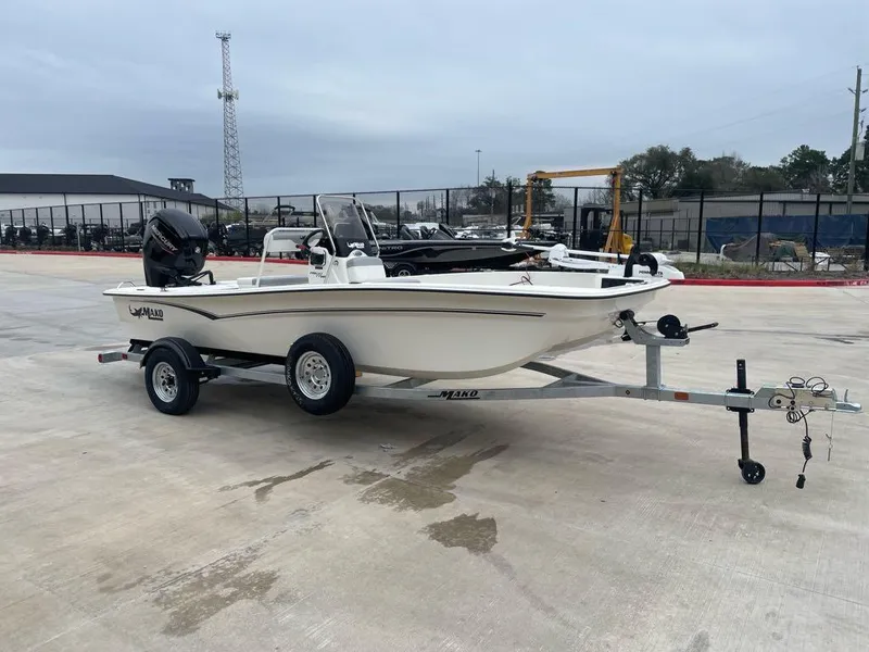 Slide: The Image of 2025 Mako Pro Skiff 17 CC boat on trailer in outdoor setting. - 1