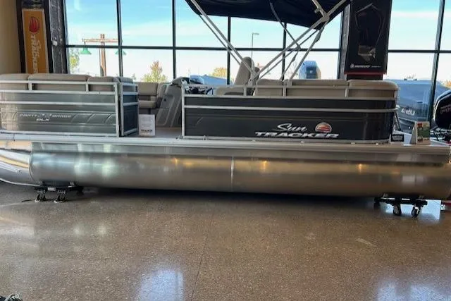 The Image of 2025 Sun Tracker Party Barge 22 DLX pontoon boat displayed indoors. - 0