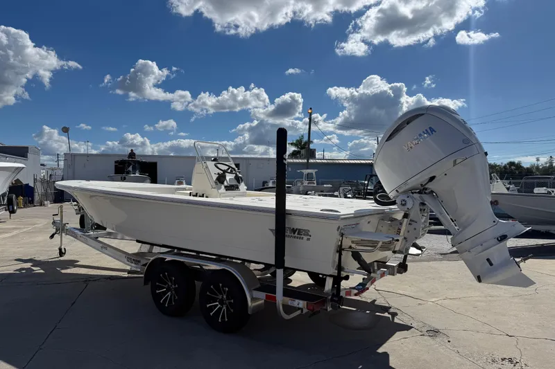 Slide: The Image of 2025 Hewes Redfisher 21 boat with Yamaha engine on trailer under blue sky. - 3