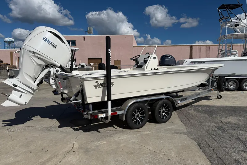 Slide: The Image of 2025 Hewes Redfisher 21 boat with Yamaha engine on a trailer, parked outdoors. - 4