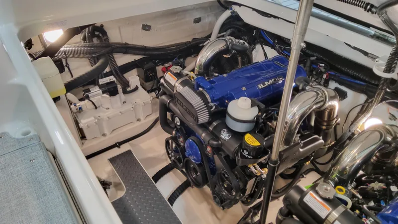 Slide: The Image of Engine compartment of 2025 Formula 350 Crossover Bowrider I/O, showcasing a powerful blue engine. - 14