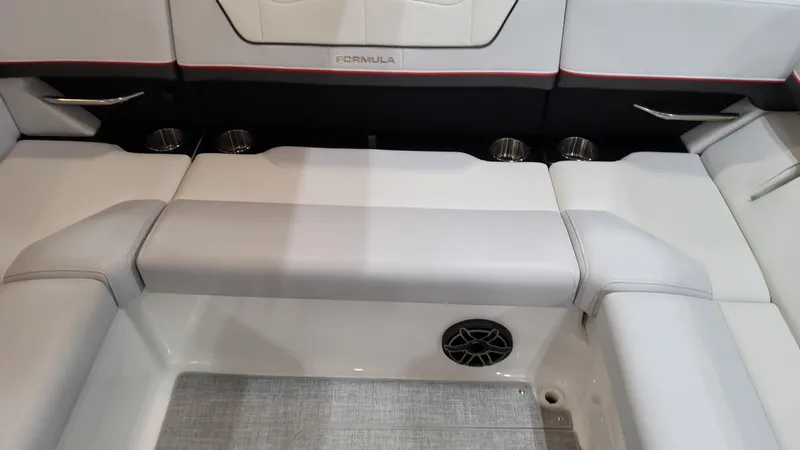 Slide: The Image of 2025 Formula 350 Crossover Bowrider I/O interior seating with cup holders and speaker. - 19