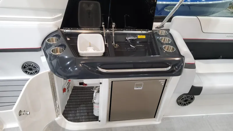 Slide: The Image of 2025 Formula 350 Crossover Bowrider I/O boat kitchenette with sink and storage. - 25