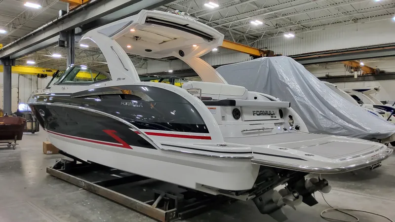 Slide: The Image of 2025 Formula 350 Crossover Bowrider I/O in a showroom, showcasing sleek design and luxury features. - 3