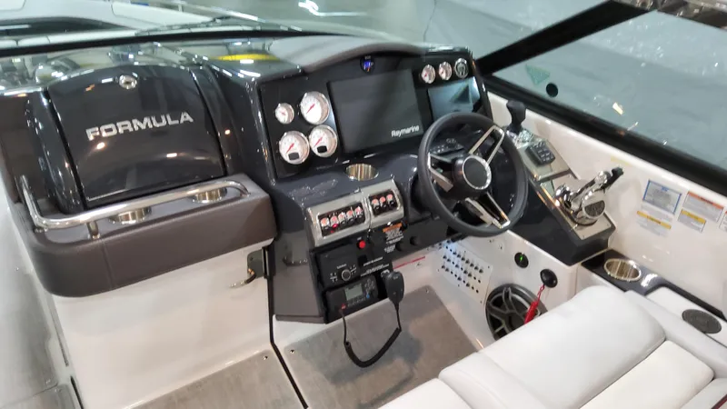 Slide: The Image of 2025 Formula 350 Crossover Bowrider I/O dashboard with steering wheel and control panel. - 30